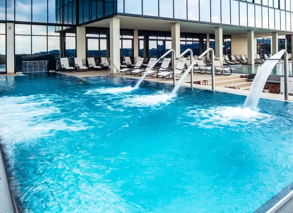 Resort-style pool with water features and lounge chairs